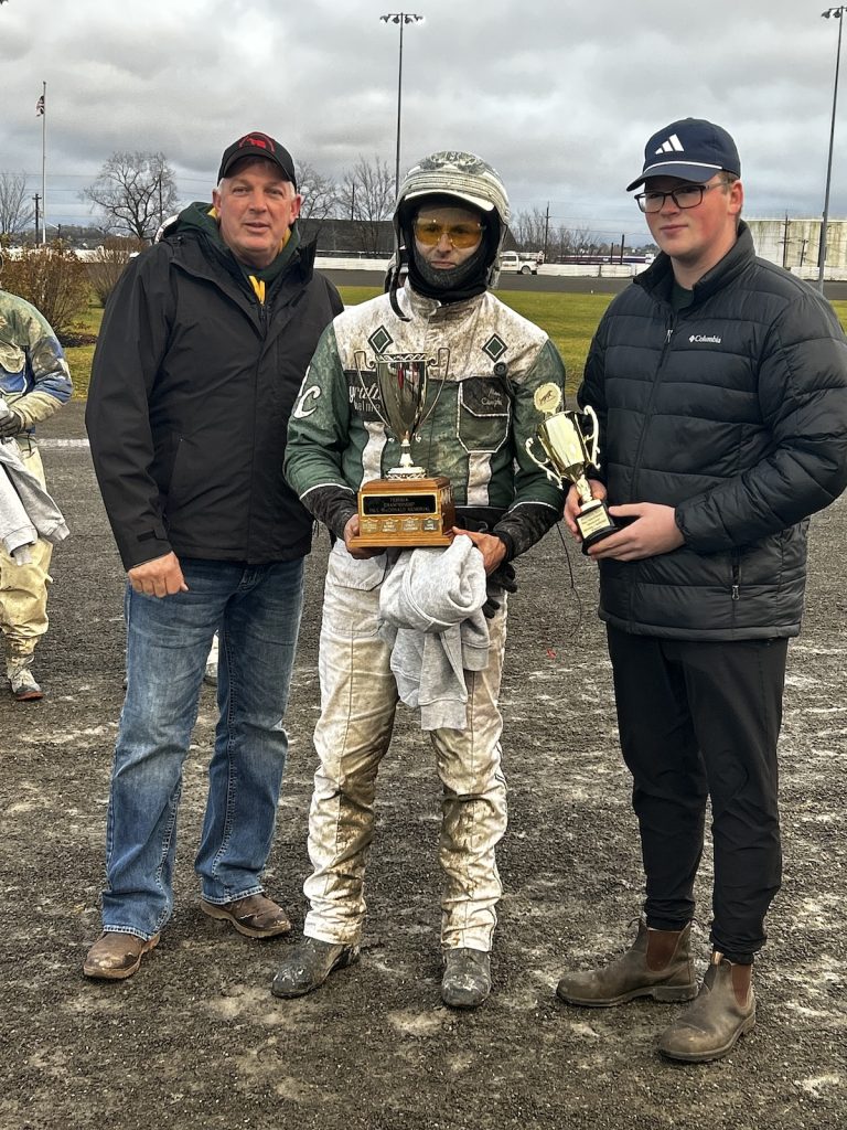 Marc Campbell receives the Paul MacDonald Memorial Trophy from P.E.I. Standardbred Horse Owners's Association President James Perrot, left, and the late Paul MacDonald's grandson Devin MacDonald, right. Red Shores Photo